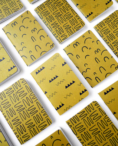 Group of gold patterned notebooks —  designed by Cotton & Flax