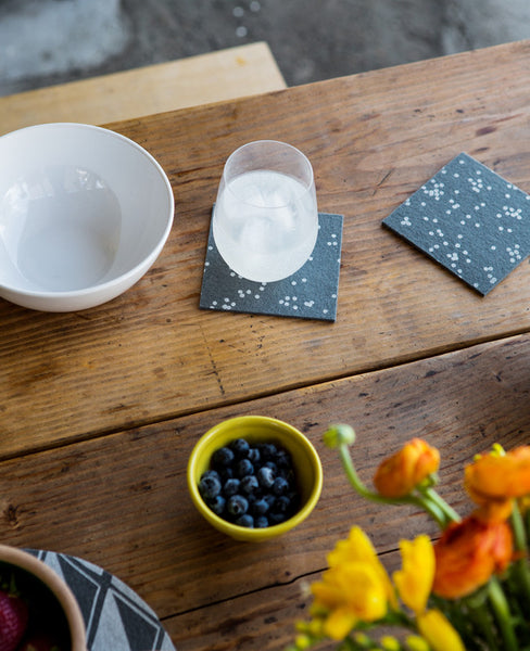 Grey wool felt coasters decorating a dinner table