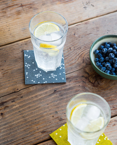 Wool felt coasters holding drinks at happy hour