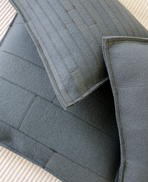 Grey wool felt throw pillow pile