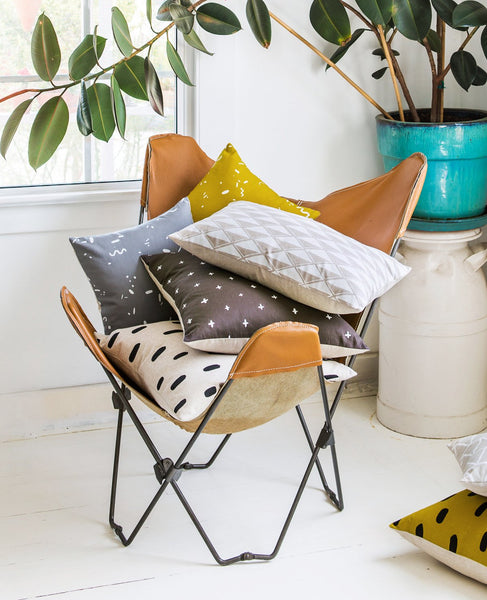 Pile of decorative throw pillows from Cotton & Flax