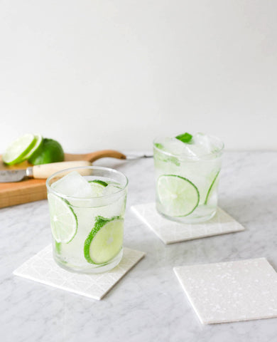 White felt coasters holding happy hour drinks - designed by Cotton & Flax