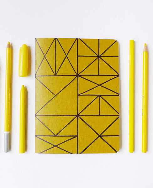 Grid notebook with yellow pencils